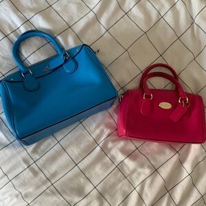 Two Coach purses, good condition, pink and blue.